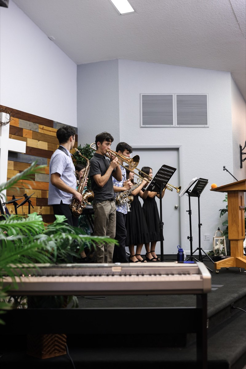 Students playing brass instruments during a youth gathering