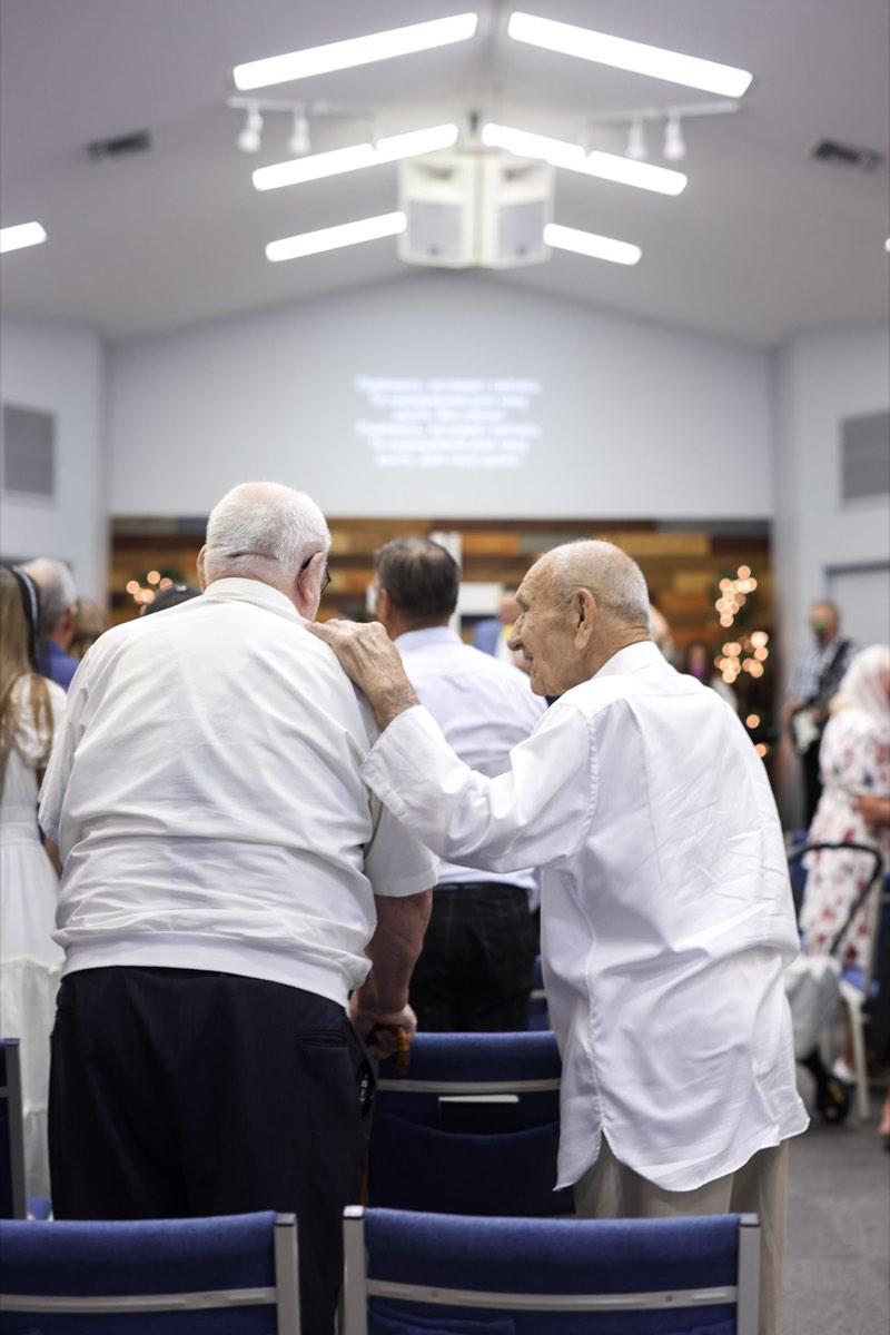 Two men embracing during a service