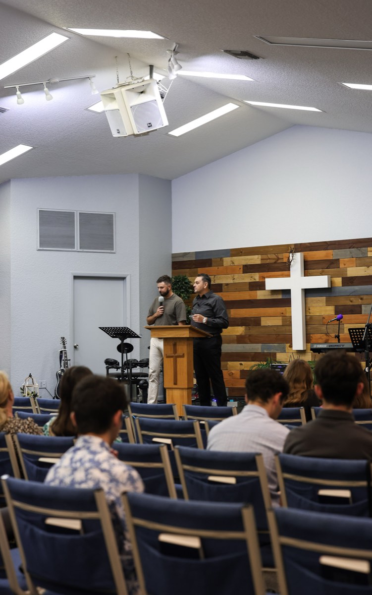 A camera positioned at the back of the sanctuary during a service