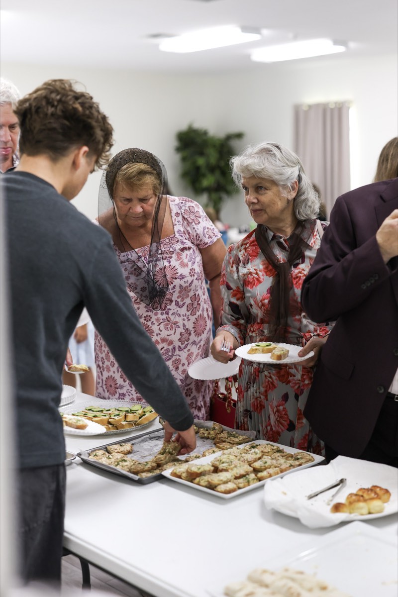 Volunteers serving food at a church gathering